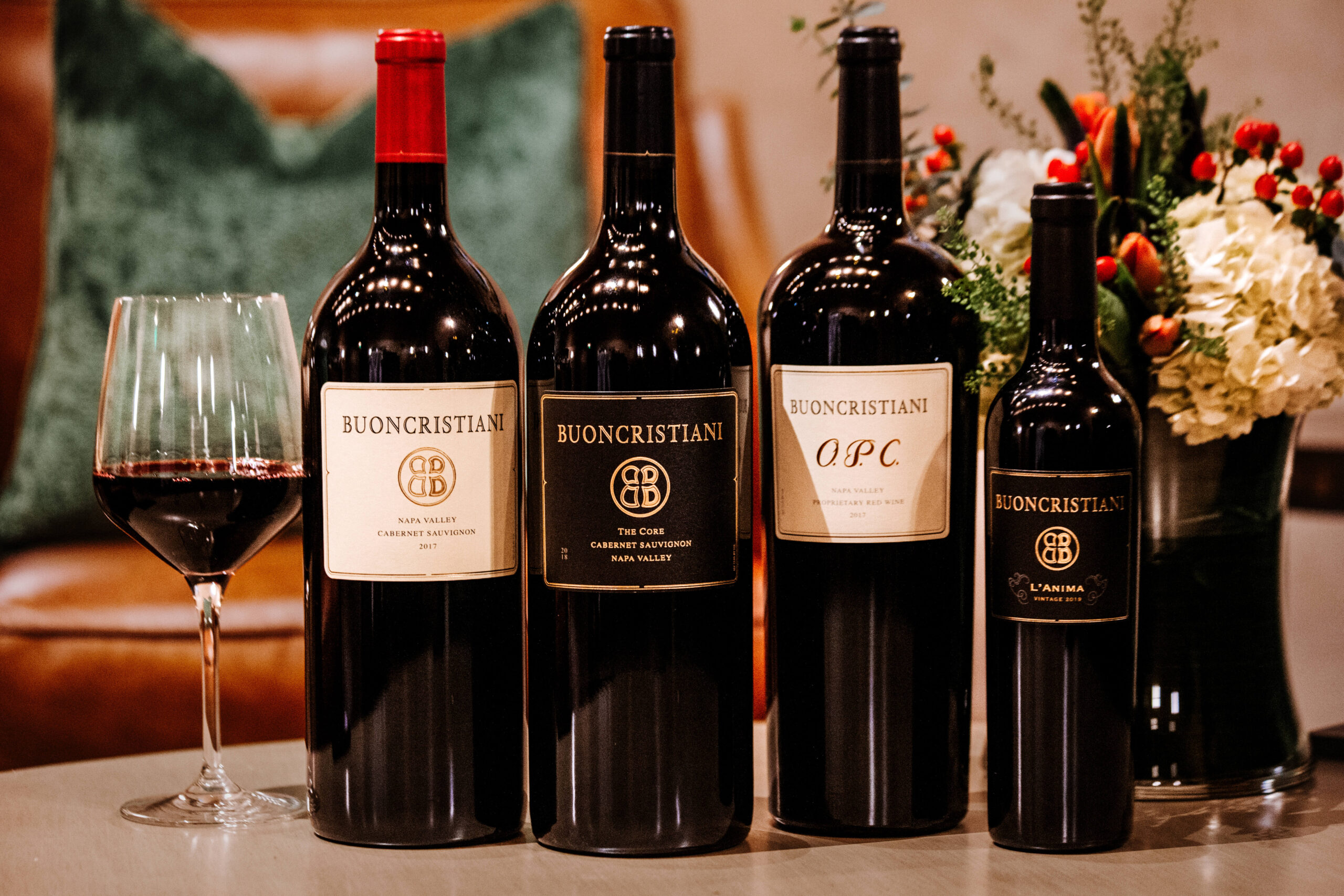 The Buoncristiani wine portfolio — four bottles with a glass