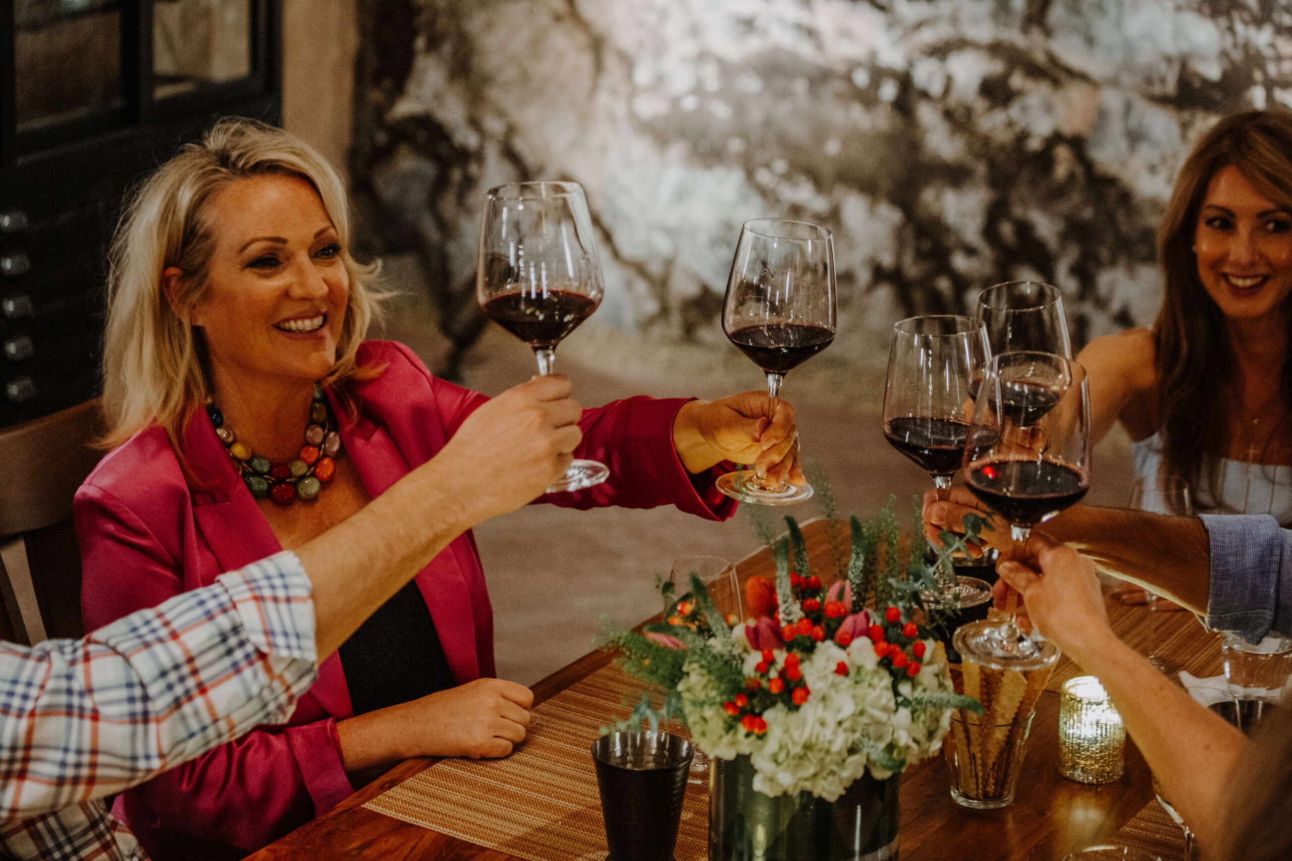 Guests toasting at a cave table tasting at Buoncristiani