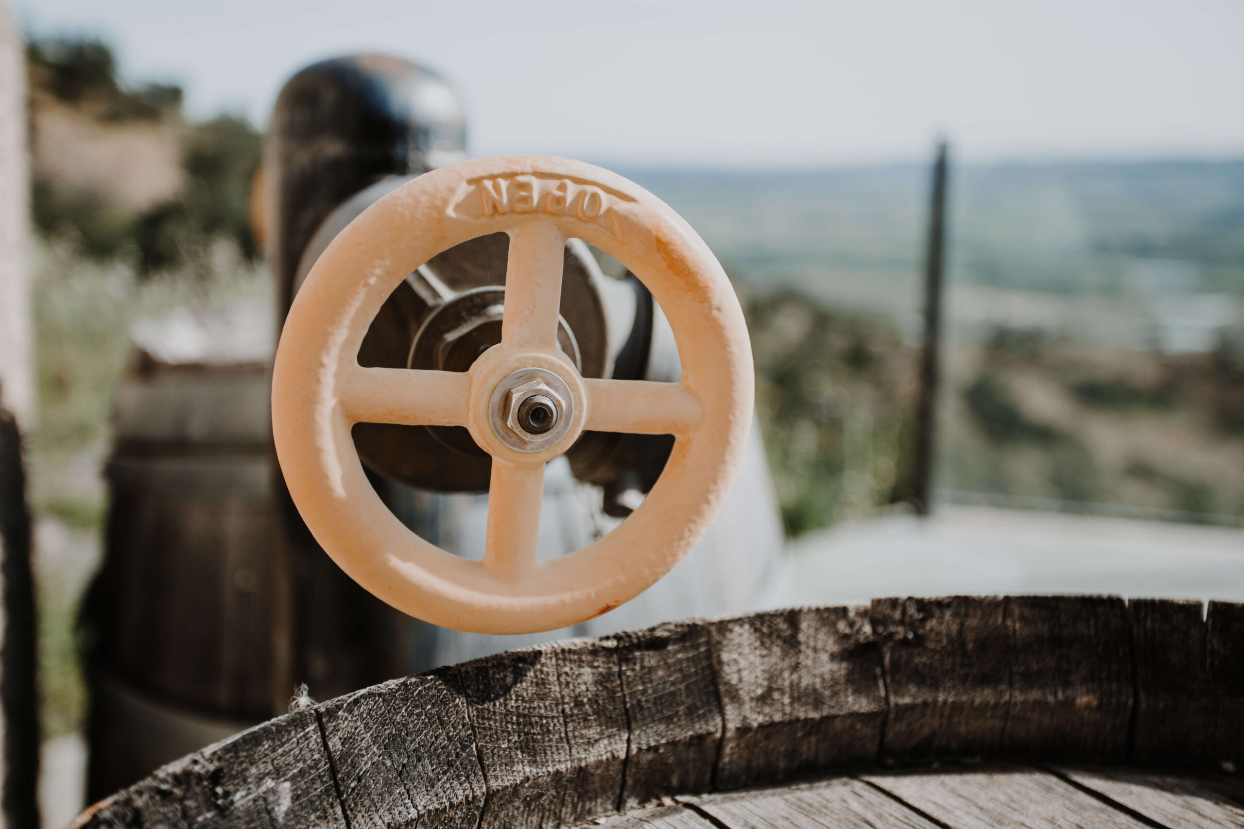 Vintage valve wheel on a barrel in the cave